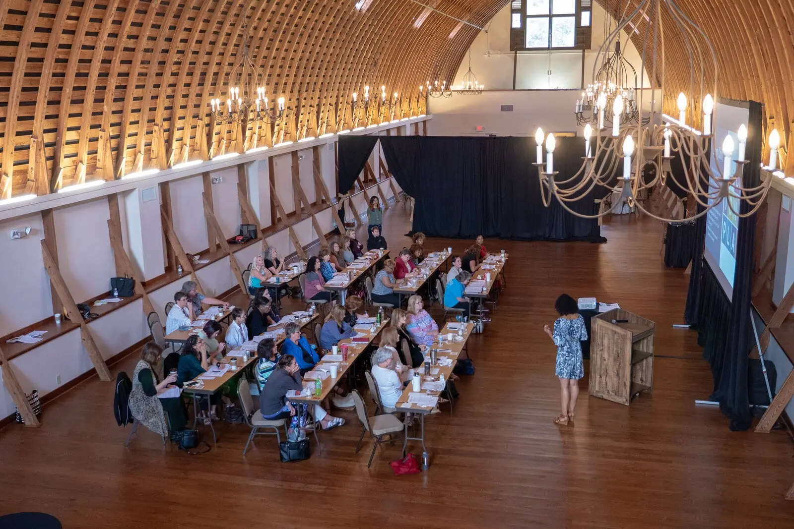 Conference in the Loft with a stage and screens