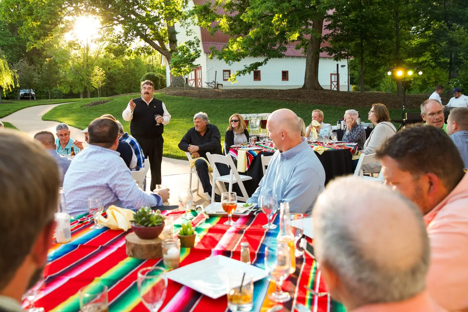 Guests at an outdoor dinner on the lawn